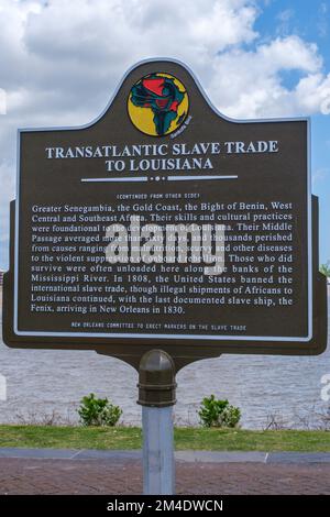 NEW ORLEANS, LA, USA - APRIL 4, 2022: Transatlantic Slave Trade to Louisiana historic marker on the Mississippi River in Woldenberg Park Stock Photo