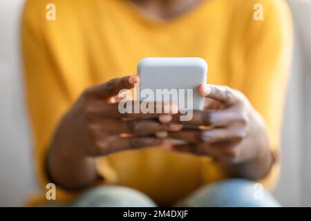 Hands of black woman using modern cell phone, cropped Stock Photo
