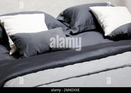 Double bed with pillows, cushions and blankets. Selective focus. Stock Photo