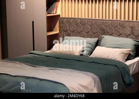 Master bedroom with stylish modern furniture set. Selective focus. Stock Photo