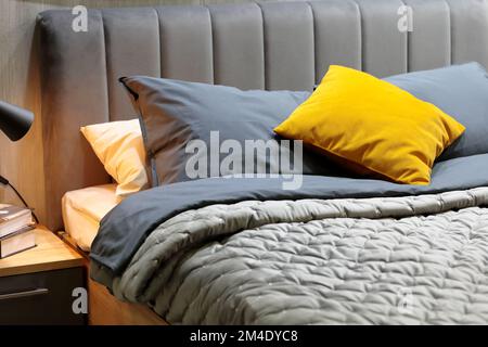 Pillows, cushions and blankets on a bed in bedroom. Selective focus. Stock Photo