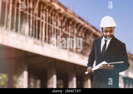 African architects engineer manager with tablet work together in the inside the construction building site Stock Photo