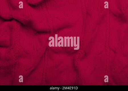 Crumpled knitted viva magenta fabric, closeup Stock Photo