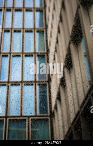 A low angle of Raindrops on a window of the office building Stock Photo
