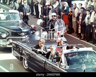 Picture of President Kennedy in the limousine in Dallas, Texas, on Main Street, minutes before the assassination. Also in the presidential limousine are Jackie Kennedy, Texas Governor John Connally, and his wife, Nellie. Stock Photo