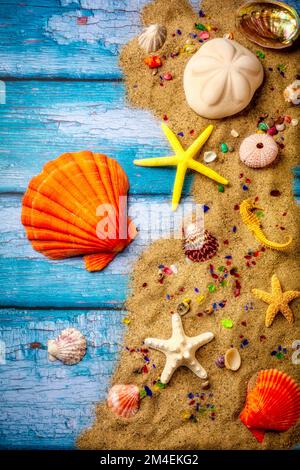 Seashore Sand And Seasshells on blue wooden dock still life Stock Photo
