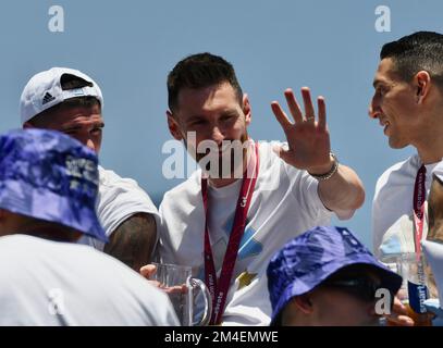 (221221) -- BUENOS AIRES, Dec. 21, 2022 (Xinhua) -- Lionel Messi of Argentina waves to the fans during parade after the team winning the Final of the 2022 FIFA World Cup in Buenos Aires, capital of Argentina, Dec. 20, 2022. (TELAM/Handout via Xinhua) Stock Photo