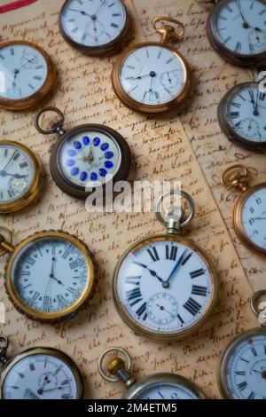 Antique Pocket Watches On Vintage Letters Still life Stock Photo