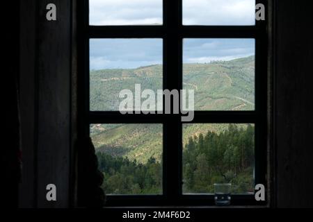 Mountain landscape viewed through the frame of a closed window in a country house Stock Photo