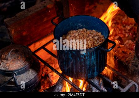 Pot of marmalade simmering on open fire Stock Photo