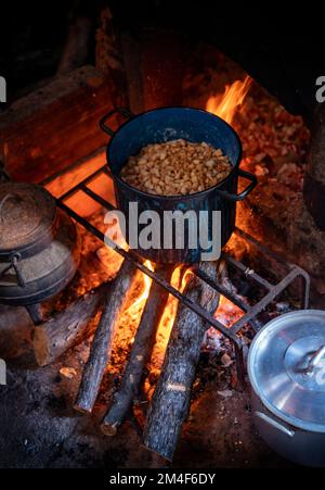 Pot of marmalade simmering on open fire Stock Photo