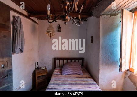 Small bedroom in an old country house in poor rural Portugal, Europe Stock Photo