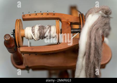 Spinning Wheel For Making Yarn From Wool Fibers. Vintage Rustic Equipment  Stock Photo - Alamy
