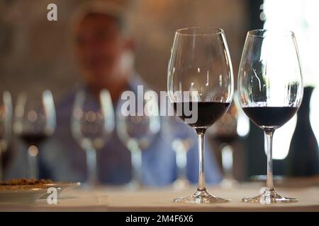 Glasses of red wine on a restaurant table Stock Photo