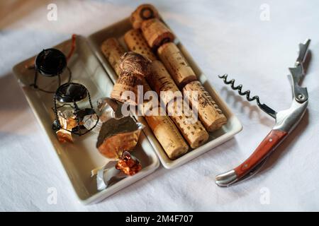 Corkscrew with wine corks viewed from above Stock Photo