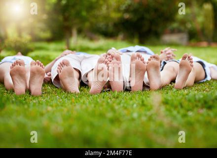 Feet of young family lying on grass in park hi-res stock photography and  images - Alamy