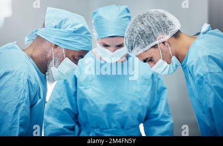Medical, teamwork and surgery with doctors in hospital for emergency, safety and operation. Helping, healthcare and collaboration with surgeon in Stock Photo