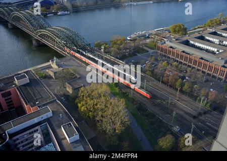 An aerial view of the Hohenzollern Bridge, River Rhine and Deutsche Bahn trains entering Cologne HBF Station, Cologne, Germany Stock Photo