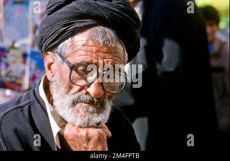 Man with glasses in the bazar of Shiraz, thinking. Stock Photo