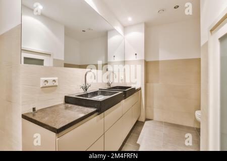 a modern bathroom with marble counter tops and white tiles on the walls, along with two sinks in front of the mirror Stock Photo