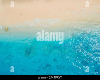 Aerial view of a tropical island with a turquoise lagoon, lush green ...