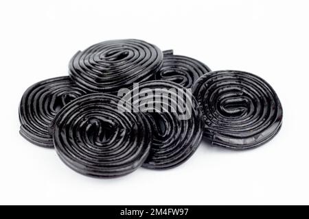 A closeup shot of black licorice wheels candy isolated on a white background Stock Photo