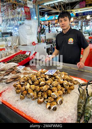 Bangkok, Thailand, Thawi Watthana,  Thonburi Market Place, Food shopping , young man, fish monger, posing With merchandise Stock Photo