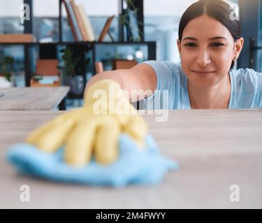 Happy, fabric and woman cleaning table furniture for hygiene, sanitary and housekeeping service. Germs, bacteria and dust with girl cleaner wipe Stock Photo