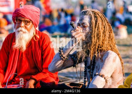 Sadhu, holy man, smoking marihuana during Kumbha Mela.   Haridwar Stock Photo