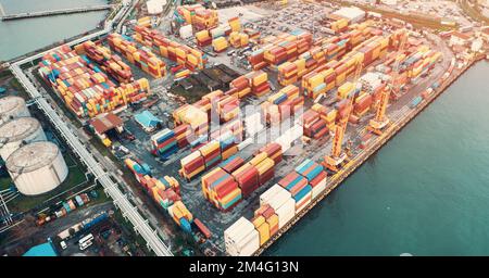 Containers in cargo freight port, aerial view. Industrial harbor, global transportation and international logistic business concept. Stock Photo