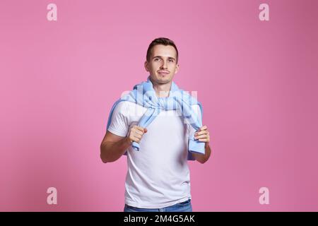 smiling young guy in white t-shirt and blue sweatshirt Stock Photo