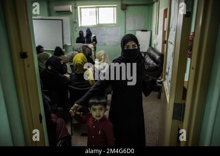 Kabul, Afghanistan. 17th Nov, 2022. A young woman and her son walk out of a classroom at a police barracks where women are being trained as police officers. When they took power in August 2021, the Taliban massively restricted women's rights. Girls' schools starting in seventh grade have been closed in much of the country, and women have largely been pushed out of the workforce. In December, the Taliban also announced it would ban women from entering universities. (to dpa 'Afghanistan's women: One setback after another') Credit: Oliver Weiken/dpa/Alamy Live News Stock Photo