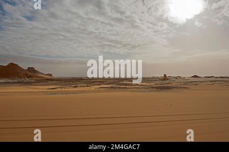 Landscape scenic view of desolate barren western desert in Egypt with sand dunes and rocky mountain Stock Photo