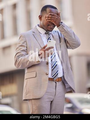 Facepalm, phone and city with a business black man in shock after reading a text message outdoor during his commute. Unhappy, doubt and face palm with Stock Photo