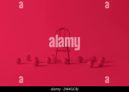 Viva Magenta color of the year 2023. Vintage chair on crimson red background. Photo is toned of 2023 trendy color. Stock Photo