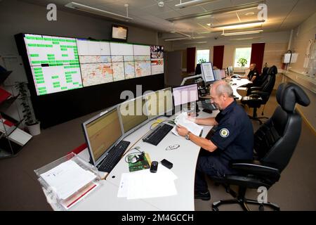 A fire station. Rescue commander in a communication room of the ...