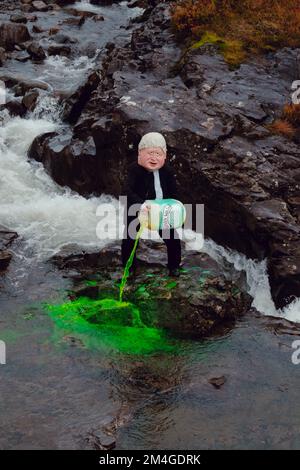 Scotland, UK. 25th October 2021. A person posing as Boris Johnson and another with an oil tank for a head light fire and dump fake toxic waste in the Fairy Pools in a theatrical action staged by members of Ocean Rebellion a sister group to Extinction Rebellion ahead of the COP26 conference in Glasgow. Stock Photo
