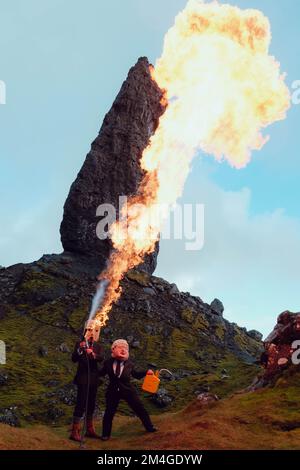 Isle of Skye, Scotland, UK. 24th Oct 2021. A person with a Boris Johnson mask and another with an Oil tank for a head, representing Oil companies, use a flame-thrower to burn a tree that represents the last tree on earth. This theatrical protest was staged by Ocean Rebellion, a sister movement of Extinction Rebellion, in the Old Man of Storr, Isle of Skye in Scotland before the start of COP 26 in Glasgow. Stock Photo