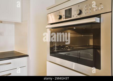 a kitchen with an oven and counter space in the corner, taken from the front view to the right side Stock Photo