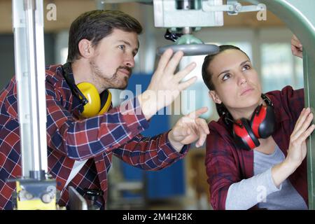 man and woman with machine cnc Stock Photo