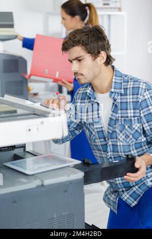 technician man opening photocopy machine in a office Stock Photo - Alamy