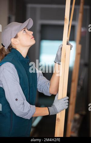 carpenter testing wood plank evenness and choosing best one Stock Photo