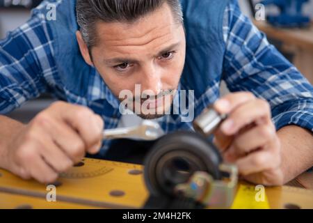 mechanic checking the car part in service station Stock Photo