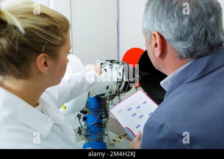 woman and man engineers testing circuit board Stock Photo