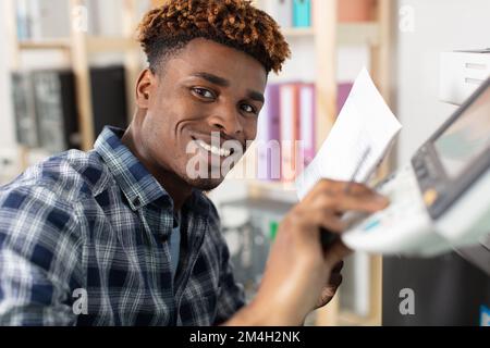 man reading instruction for 3d printer Stock Photo