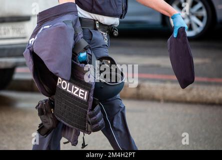 Schorndorf, Germany. 21st Dec, 2022. A police officer wears a bulletproof vest in his hand. Two people were killed in a violent attack in Schorndorf. Credit: Christoph Schmidt/dpa/Alamy Live News Stock Photo