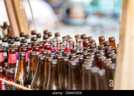 Closeup of empty beer bottles stacked in restaurant Stock Photo