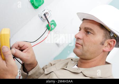 close-up of a male technician doing meter reading using mobilephone Stock Photo