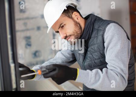 electrician installing energy saving meter Stock Photo