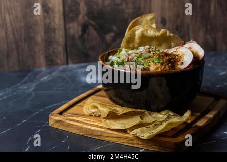 mexican food meat bowl, with meat juice cilantro and onion on the cover, mexican wooden plates Stock Photo